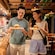 Two Guests holding their plates with sandwiches and fries from Stitch’s Ohana Grill on the Disney Adventure cruise ship